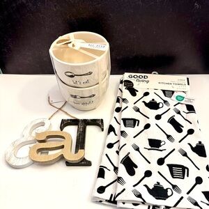 Great bowls by Rae Dunn, kitchen towels and either EAT or YUM sign.